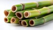 © Moosakhan - A stack of fresh green bamboo stalks with visible nodes and hollow interiors on a white background