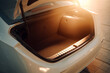 © halcon1 - Empty open trunk of a modern white sedan car in bright sunset light. Close up of spacious car boot capacity, highlighting automotive design, transport and travel storage