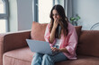 © Daniel - Frustrated sad woman feeling tired worried about problem sitting on sofa with laptop, stressed depressed girl troubled with reading bad news online, email notification about debt or negative message