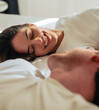 © Daniel - Beautiful happy loving young smiling couple relaxing in bed, looking at each other. Cozy home atmosphere, tenderness, closeness. Embracing, kissing. Lazy weekend, slow living concept