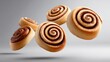 © ชลธิชา สว่างวงค์ - Cinnamon buns airborne delicious cinnamon buns in mid air swirling and suspended against a neutral background