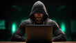 © Keopaserth - Hooded man typing on laptop in dark room with green backlight, cyber security mood and focused expression