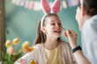 © Konstantin Yuganov - Joyful Child with Bunny Ears Having Face Painted for Easter Cele