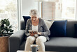 © peopleimages.com - Happy, tablet and senior woman on sofa for online ebook, website and connection on weekend. Retirement, home and elderly person on digital tech for entertainment, internet and relax in living room
