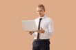 © Pixel-Shot - Young businessman working with laptop on beige background