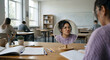 © Natsumae - Diverse group of students studying and collaborating together at a school table