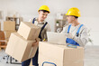 © Pixel-Shot - Male loaders working with laptop and boxes in office