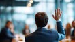© sup - Man raises hand in business meeting
