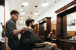 © Westend61 - Trendy hairdresser styling man's hair at salon