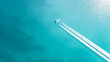 © Bonsales - Airplane soaring high over tropical ocean, leaving vapor trails, symbolizing travel, journey, and freedom