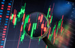© Westend61 - Magnifying glass over stock market trading graph on computer screen