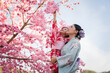 © geargodz - woman and child girl in yukata (kimono dress) with sakura flower or cherry blossom blooming in garden