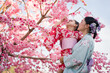 © geargodz - woman and child girl in yukata (kimono dress) with sakura flower or cherry blossom blooming in garden