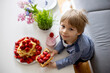 © Tomsickova - Sweet preschool child, boy, eating belgian waffle with strawberries and chocolate at home