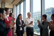 © FotoArtist - Diverse business team applauding and celebrating success in a modern office setting