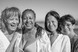 © Sabrina - Happy multiracial senior women smiling in front of camera during beach summer vacation - Elderly people with different ethnic and body - Holiday, friendship and travel concept - Black and white