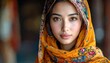 © Zanas - Beautiful woman with a colorful scarf looking at the camera.