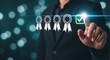 © AK_KADER - Professional in dark suit interacting with virtual interface displaying five rosette icons and a green checkmark symbolizing approval rating or quality control.