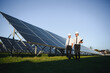 © Serhii - Portrait of engineers standing outside near solar panels