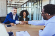 © Dragana Gordic - Business Meeting Handshake Sealing Agreement Between Diverse Colleagues In Modern Office Conference Room