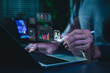 © Supatman - Artificial intelligence data analytics concept. Professional using laptop with dashboard, machine learning charts, real time data processing to generate predictive insights and business intelligence.