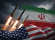 © Jim - Missiles launching against backdrop of United States and Iran flags. Geopolitical tension, military confrontation and international conflict concept. War & Conflict