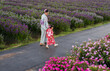 © geargodz - woman and child girl in yukata (kimono dress) walking together with flower blooming in garden