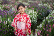 © geargodz - preschool child girl in yukata (kimono dress) with angelonia flower blooming in garden