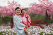 © geargodz - woman and child girl in yukata (kimono dress) with sakura flower or cherry blossom blooming in garden