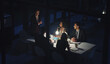 © peopleimages.com - Woman, discussion and team at night for office meeting with talk, documents or review at law firm. People, group and corporate lawyer with tech, overtime and smile for problem solving at legal agency