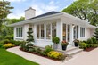 © kardaska - Modern white brick bungalow with large windows and landscaped garden