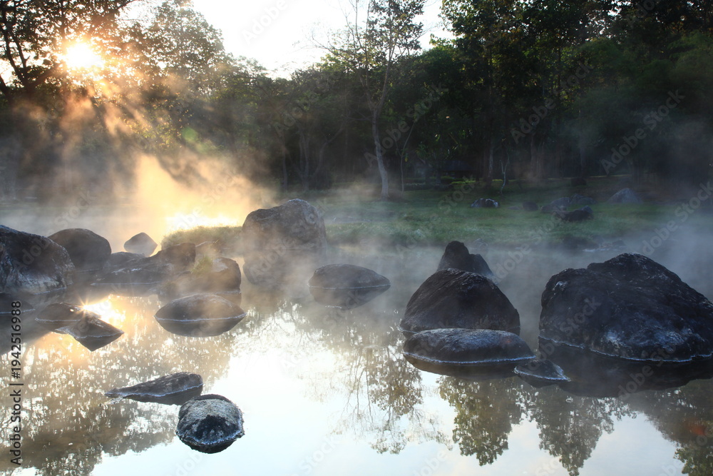 The steam from the hot spring meets the sunlight creates a beautiful ...