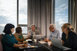 © Johnér - Senior businessman explaining strategies to coworkers sitting around table in meeting