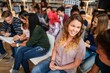 © Rawpixel.com - Group of diverse young adults in a library, engaged in conversation and study. Smiling and interacting, they represent a multicultural learning environment. Cheerful dverse people in a library.