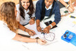 © Rawpixel.com - Students collaborating on electronics project.