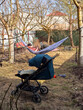 © phpetrunina14 - Father relaxing in hammock in backyard with stroller