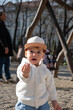 © phpetrunina14 - Toddler in white hoodie at playground on sunny day Portrait