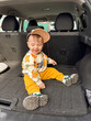 © phpetrunina14 - Portrait Toddler sitting in open car trunk during family road trip