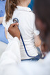 © DC Studio - Close-up image of a doctor listening to heartbeat of a child with stethoscope. At doctor appointment in clinic office, an African American physician examines health of a young girl.
