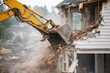 © Andrii  - Excavator demolishing residential house building during construction site demolition process