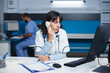 © DC Studio - Caucasian doctor in modern office sitting at desk, speaking on landline. With a desktop PC on the table, a female physician is making a phone call. Technology and communication in healthcare.