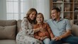 © Nathan - Happy Family Sitting Together on Couch in Cozy Living Room Smiling and Embracing
