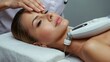 © Nathan - Woman Receiving Facial Treatment with Technology in a Modern Spa Environment