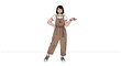 © microstock - Young Woman Standing Confidently in Stylish Overalls.