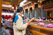 © leungchopan - Lady performing prayer ritual inside temple hall