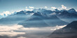 © den-belitsky - Panoramic aerial view of the Swiss Alps with snow-capped peaks and low clouds at sunrise. Bright morning light and blue sky over rugged alpine mountains in Switzerland at dawn. Top view. Landscape