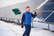 © Serhii - Engineer worker clearing snow from solar panels in winter