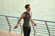 © Teodor Lazarev - Young man engaging in outdoor fitness, exercising with a jump rope at the pier, staying active and focused on training for health and well-being
