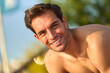 © Teodor Lazarev - Young smiling man looking at camera, expressing happiness, confidence, and positive emotion outdoors during sunny summer day, enjoying leisure activities and wellbeing