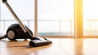 © Bonsales - Modern vacuum cleaner cleaning hardwood floor in bright living room, home maintenance and domestic chore concept